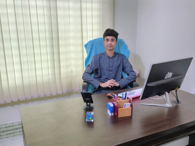 Business leader and CEO in office, focused on work at a modern desk.